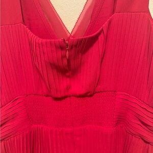 Sleeveless red dress with pleats